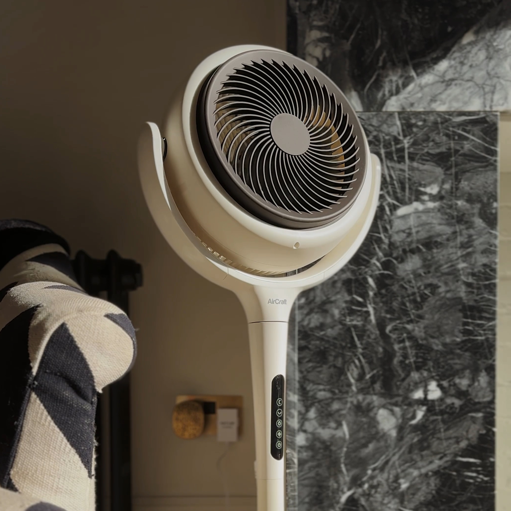 LUME fan with power adaptor plugged in in the background